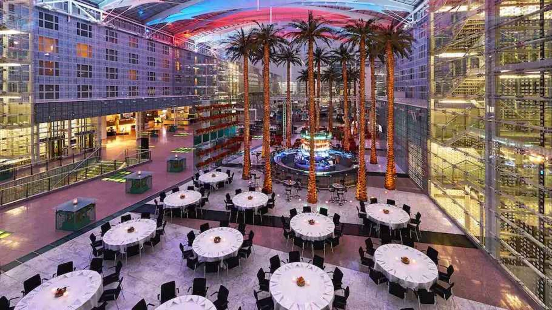 Spacious outdoor patio with palms at the Hilton Munich Airport.