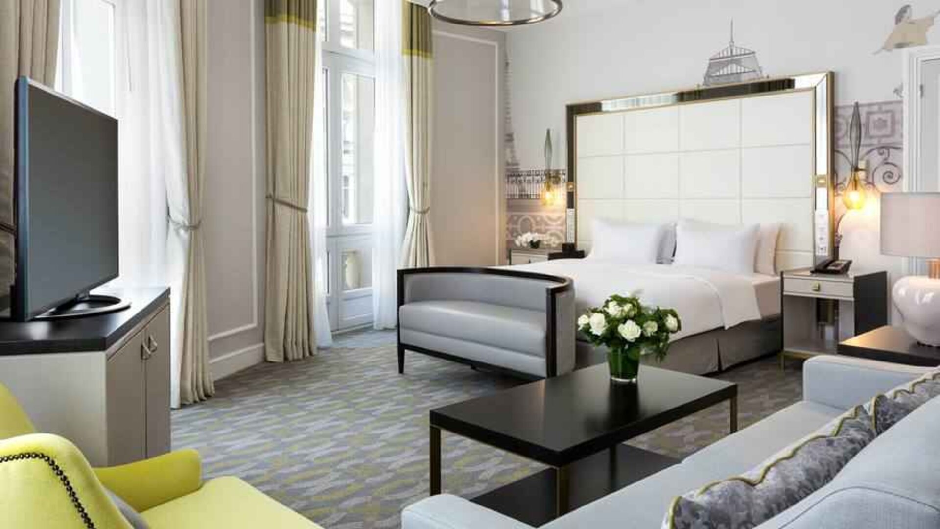 Spacious hotel suite with sofa and TV screen at the Hilton Paris Opera.