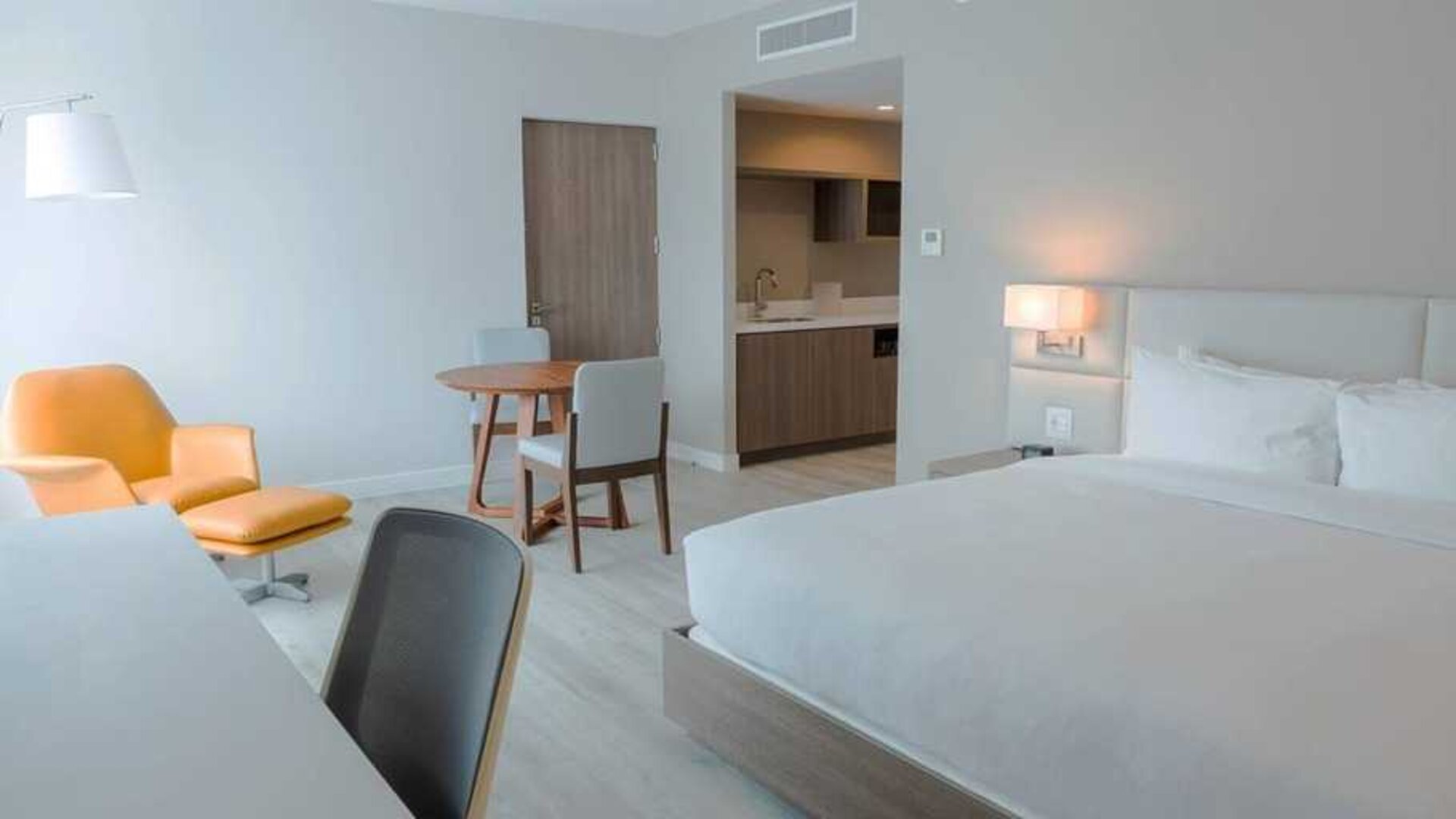 spacious king suite with work desk and lounge area at Hilton Garden Inn Santa Ana San Jose.