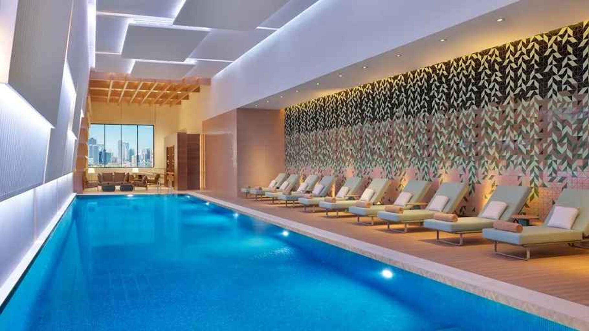 gorgeous indoor pool with pool beds at DoubleTree by Hilton Sharjah Waterfront Hotel & Residences.
