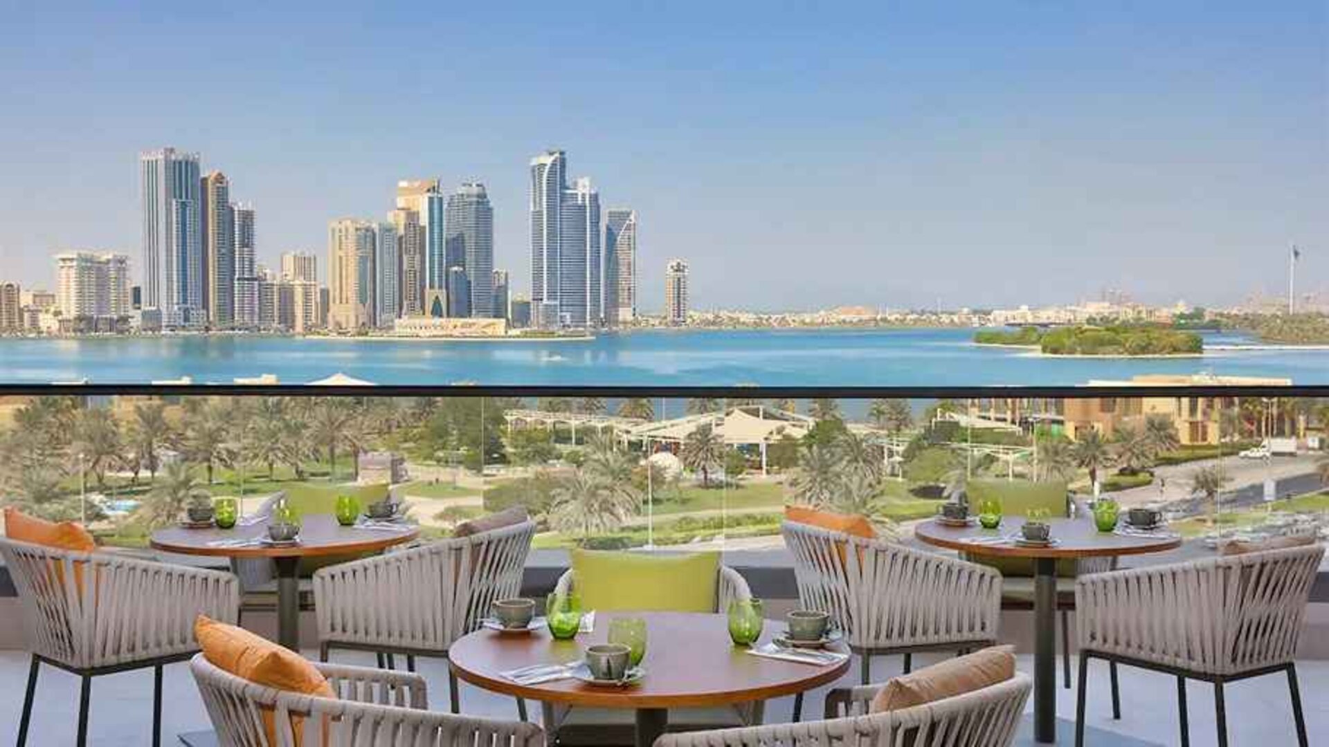 lovely outdoor terrace with gorgeous water/city views ideal as a coworking space at DoubleTree by Hilton Sharjah Waterfront Hotel & Residences.