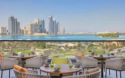 lovely outdoor terrace with gorgeous water/city views ideal as a coworking space at DoubleTree by Hilton Sharjah Waterfront Hotel & Residences.