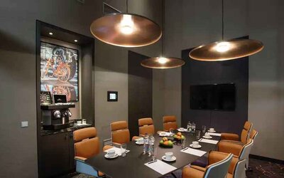 Meeting room with TV screen and coffee machine at the Hilton Amsterdam Airport Schiphol.