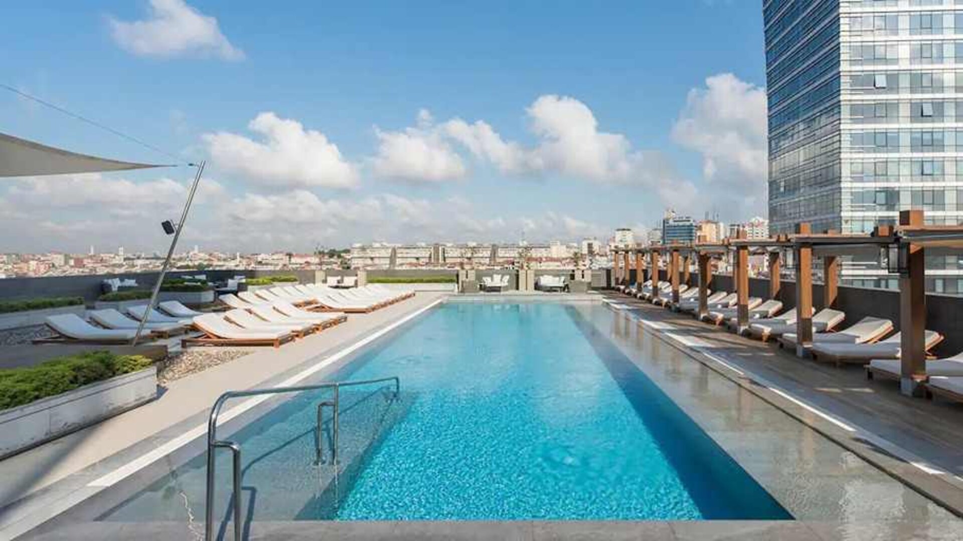 stunning outdoor pool with sun beds at Hilton Istanbul Bomonti Hotel & Conference Center.