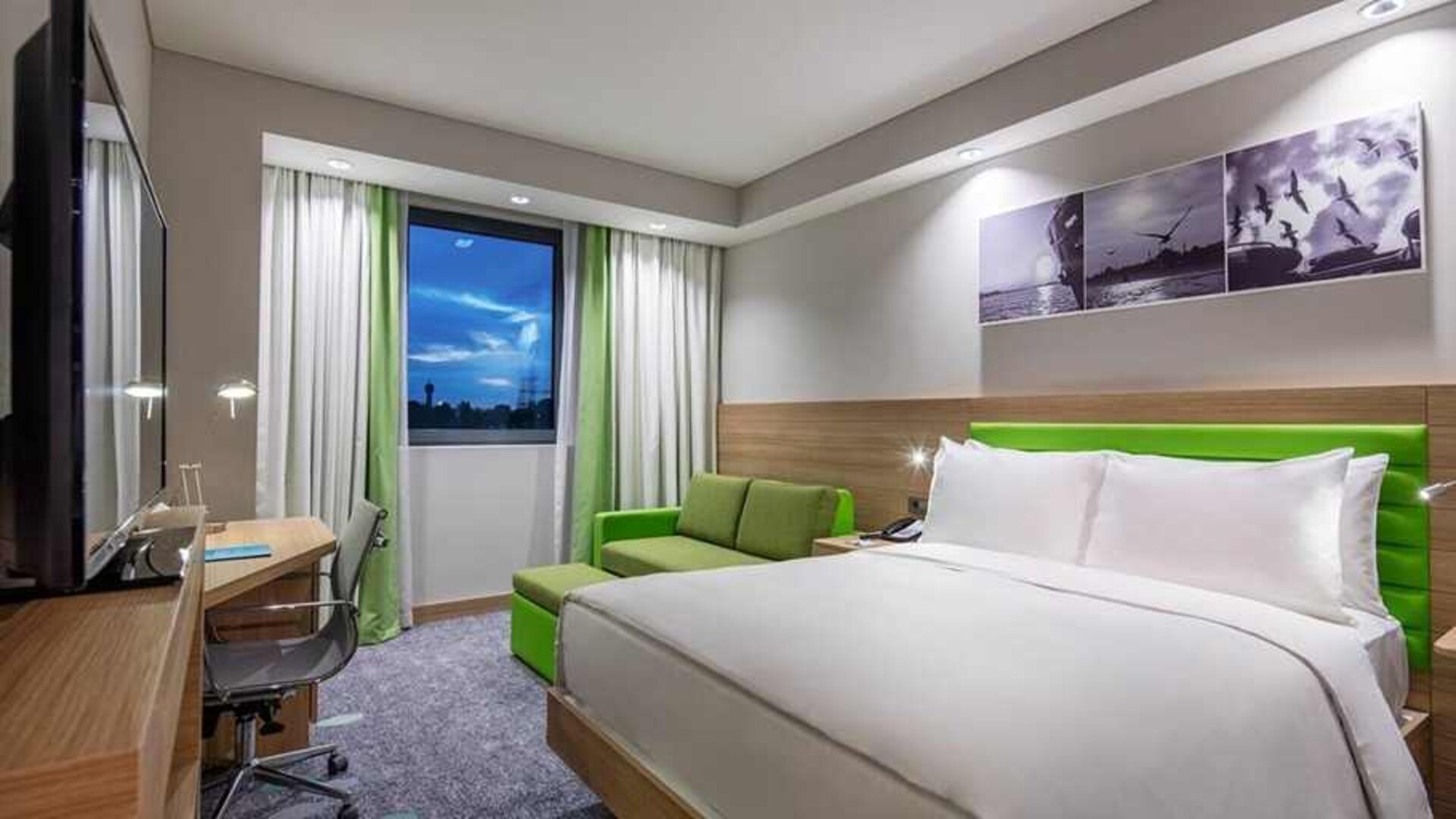 colourful king room with work desk and TV at Hampton by Hilton Istanbul Zeytinburnu.