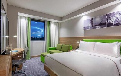 colourful king room with work desk and TV at Hampton by Hilton Istanbul Zeytinburnu.