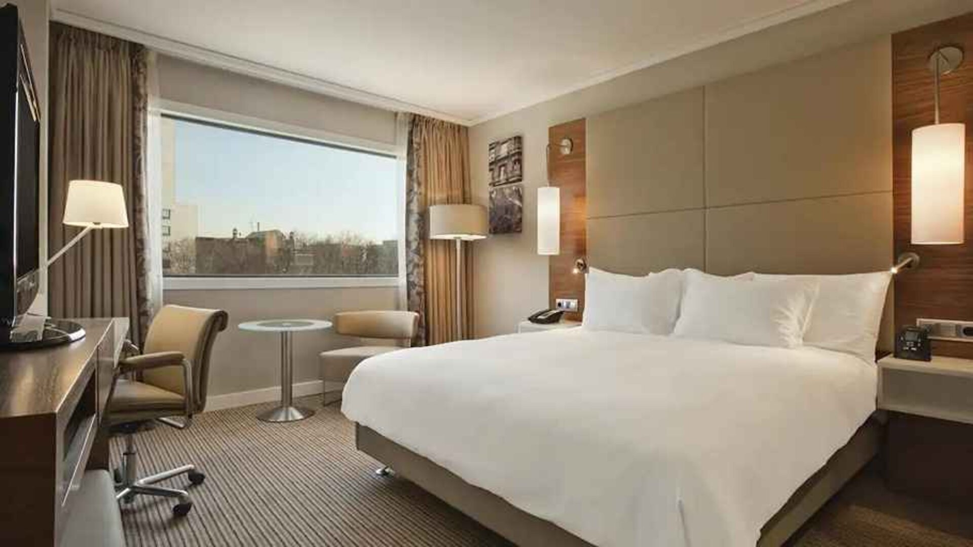 spacious king room with TV and work desk at Hilton Barcelona.