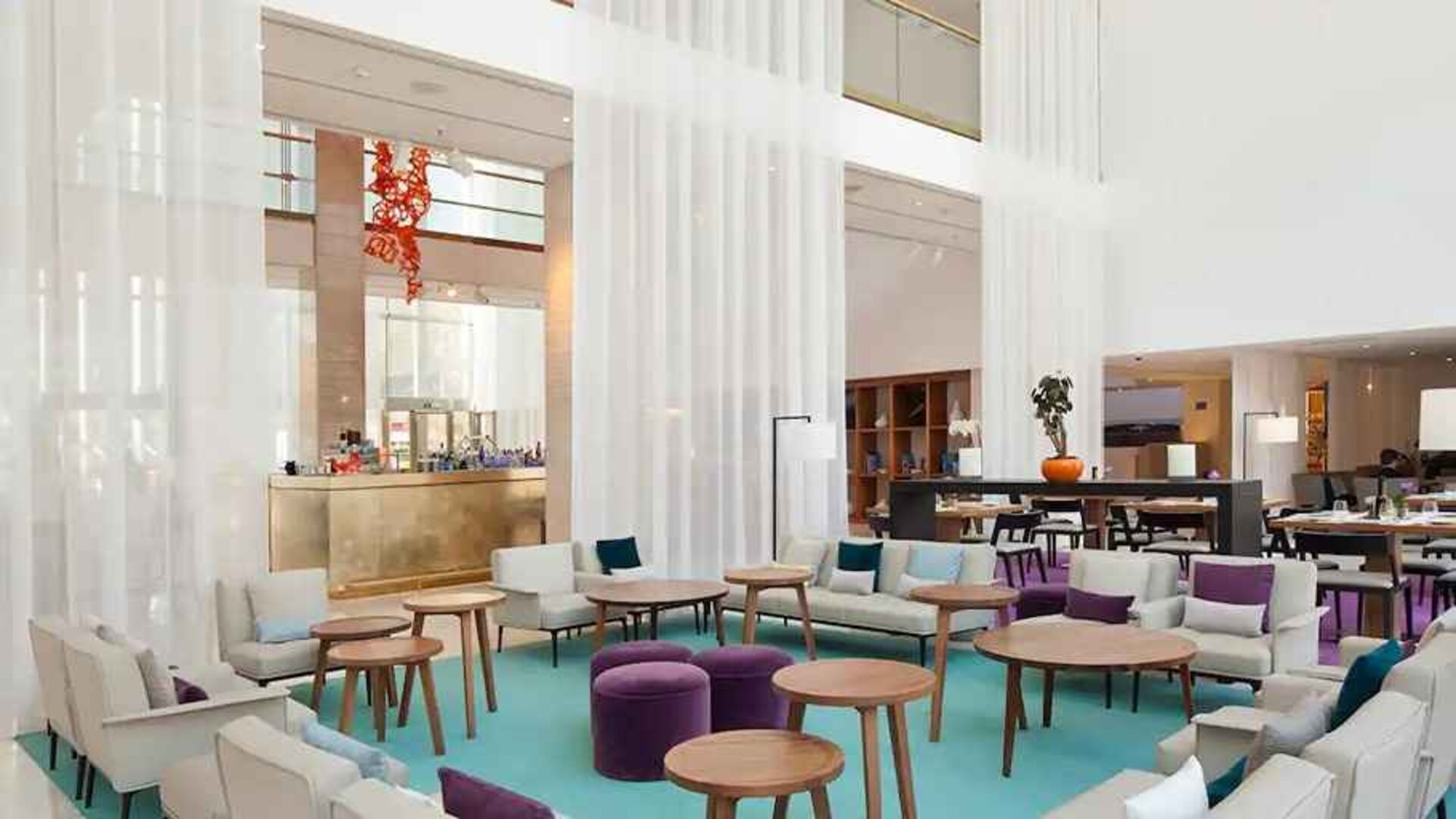comfortable lobby and coworking space with lots of natural light at Hilton Barcelona.