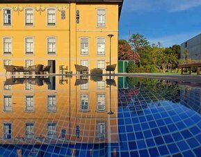 Outdoor patio suitable for co-working at the Boeira Garden Hotel Porto Gaia, Curio Collection by Hilton.