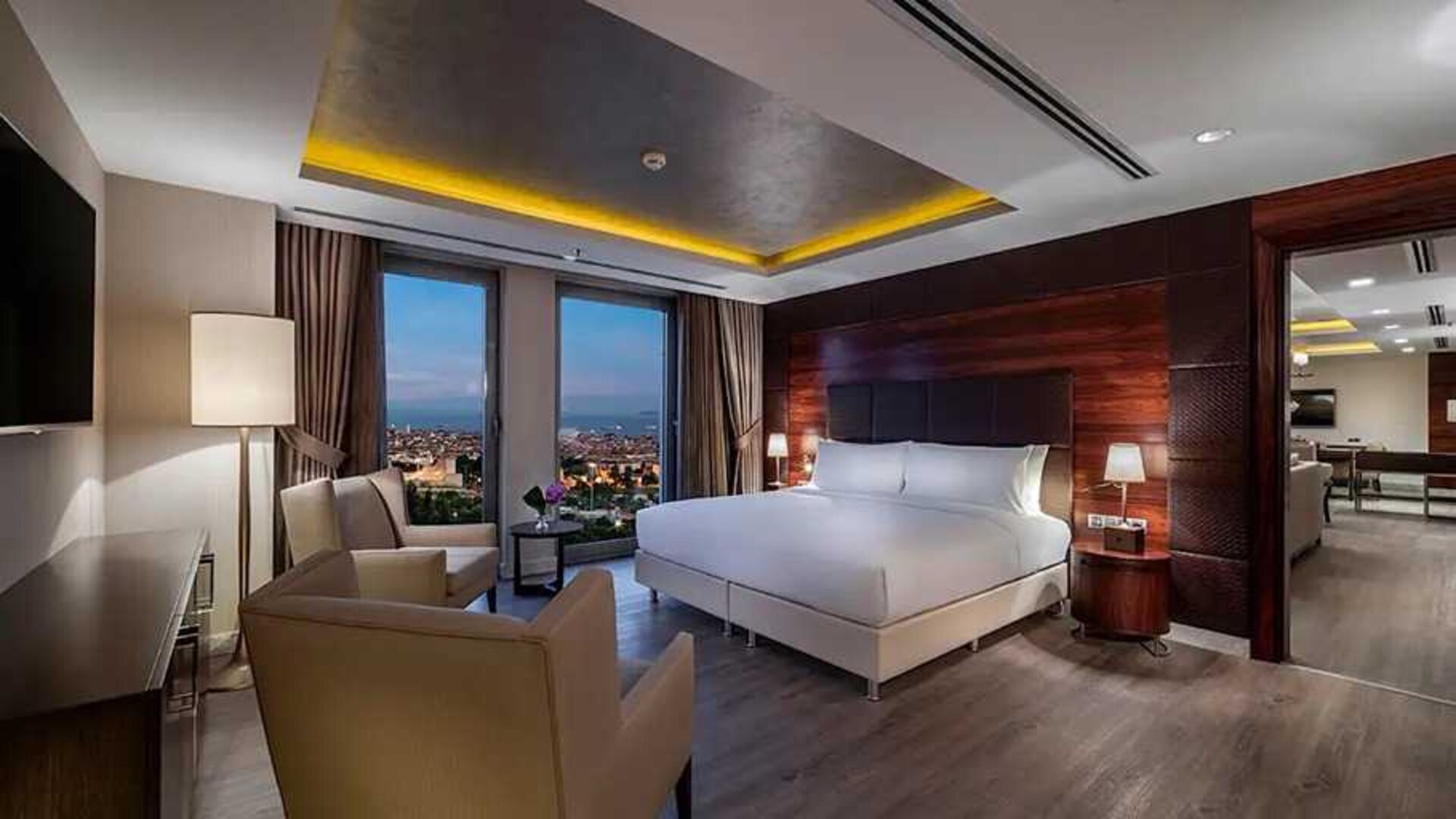 spacious king suite with TV, desk and chair, and lounge area at DoubleTree by Hilton Istanbul Topkapi.