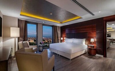 spacious king suite with TV, desk and chair, and lounge area at DoubleTree by Hilton Istanbul Topkapi.