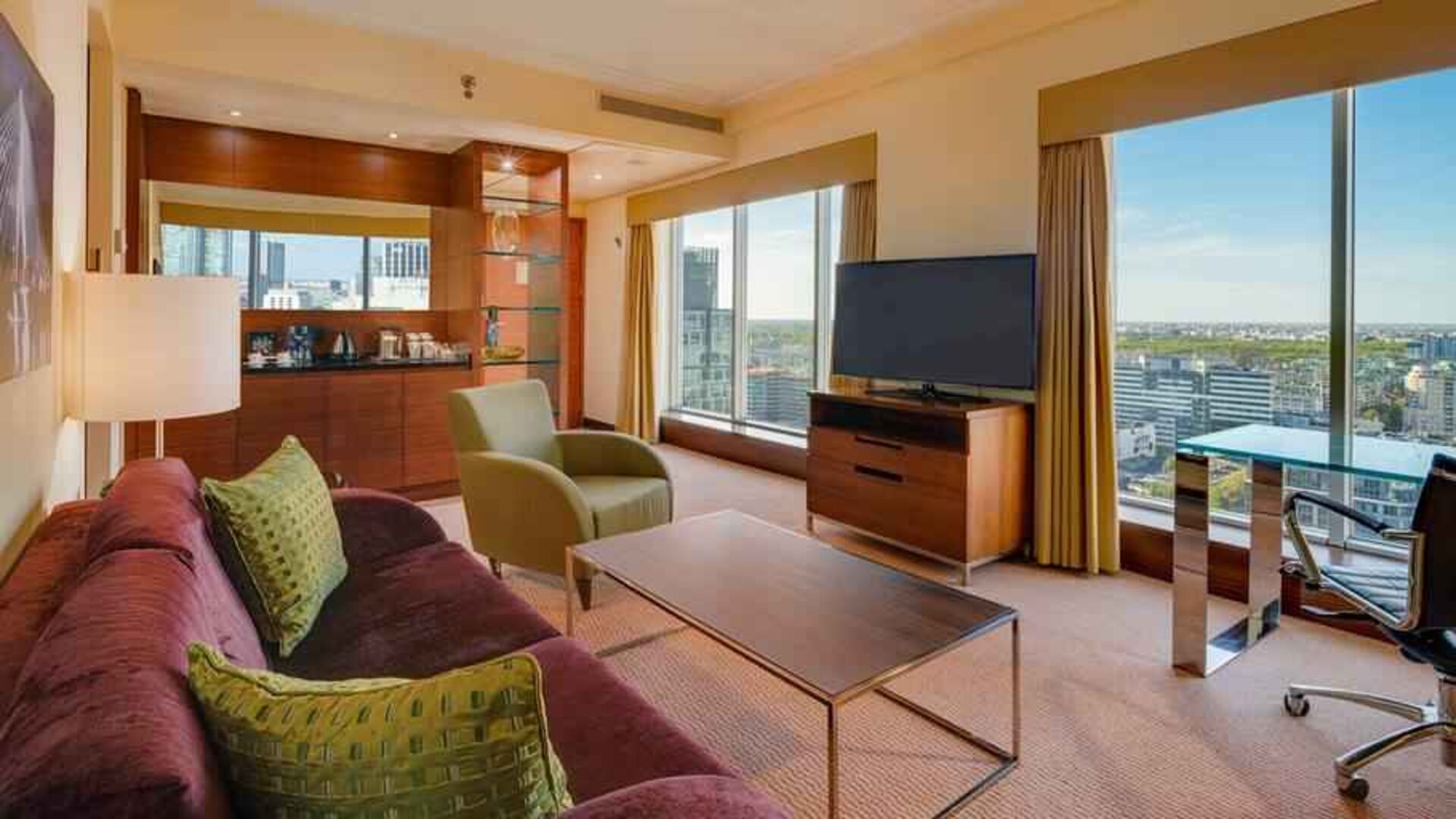Spacious living room with view, working station and sofa at the Hilton Warsaw City.