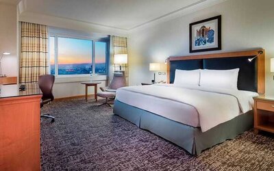 spacious delux king room with desk, chair, and TV at Adana HiltonSA.