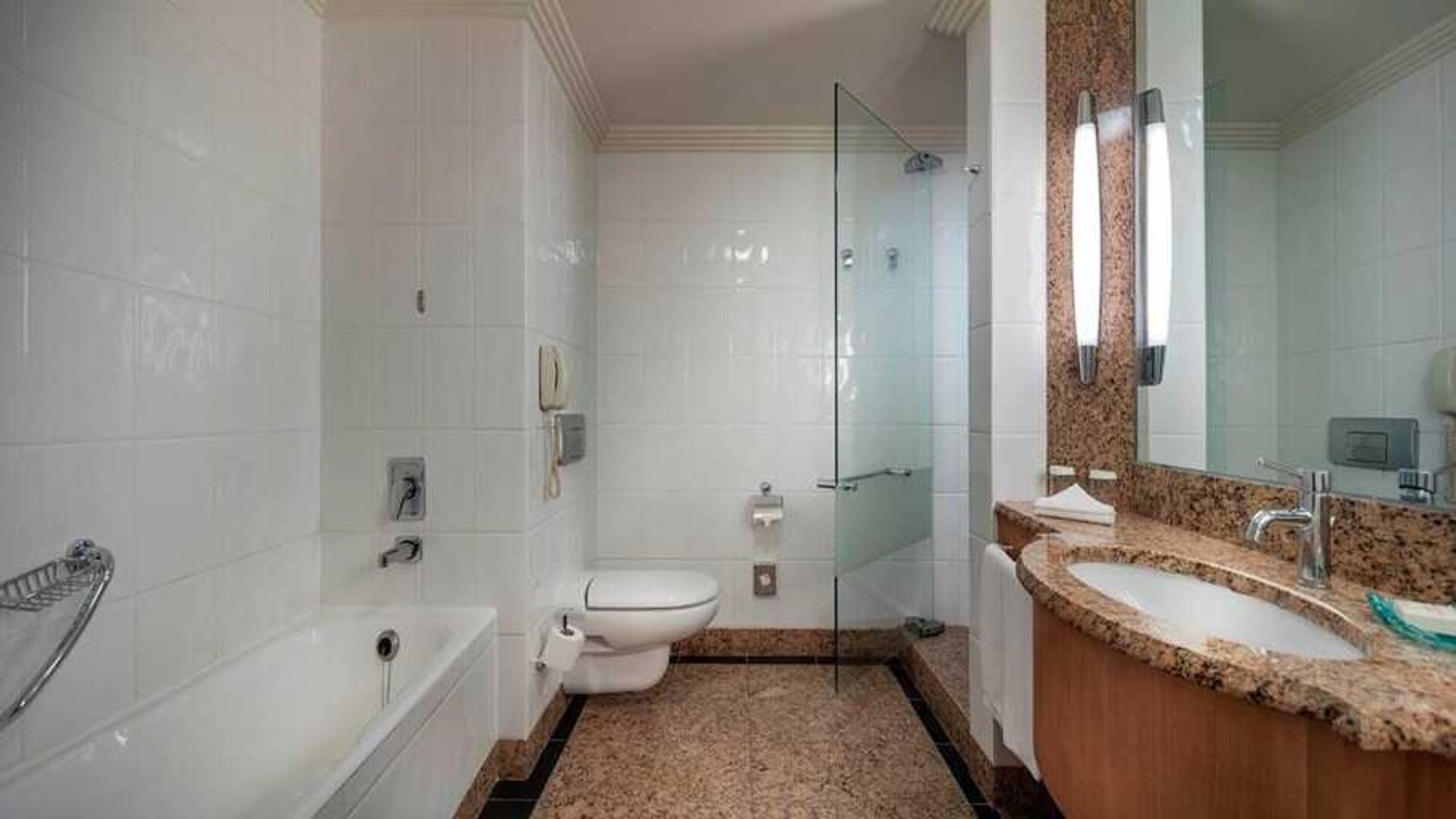 spacious bathroom with bath and shower at Adana HiltonSA.