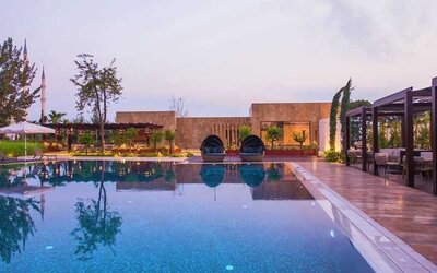 stunning outdoor pool with sun beds and seating area at Adana HiltonSA.