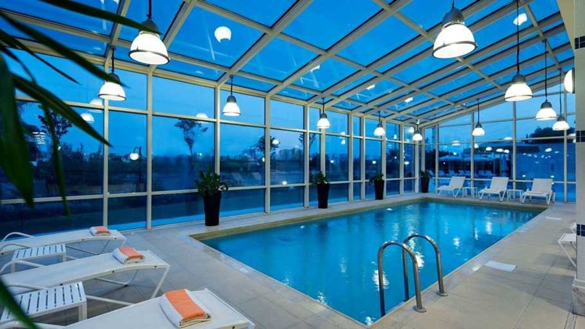 beautiful indoor pool with sunbeds at Adana HiltonSA.