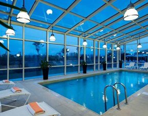 beautiful indoor pool with sunbeds at Adana HiltonSA.