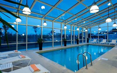 beautiful indoor pool with sunbeds at Adana HiltonSA.