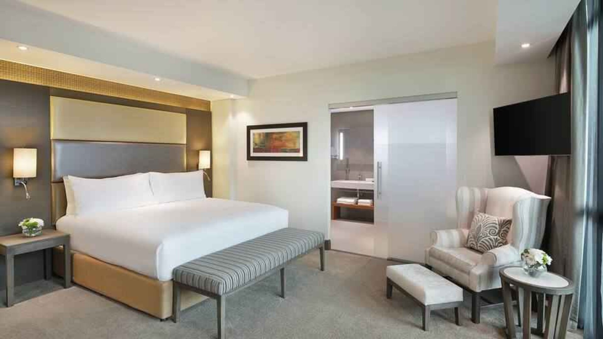 Elegant king suite with TV screen at the Legend Hotel Lagos Airport, Curio Collection by Hilton.