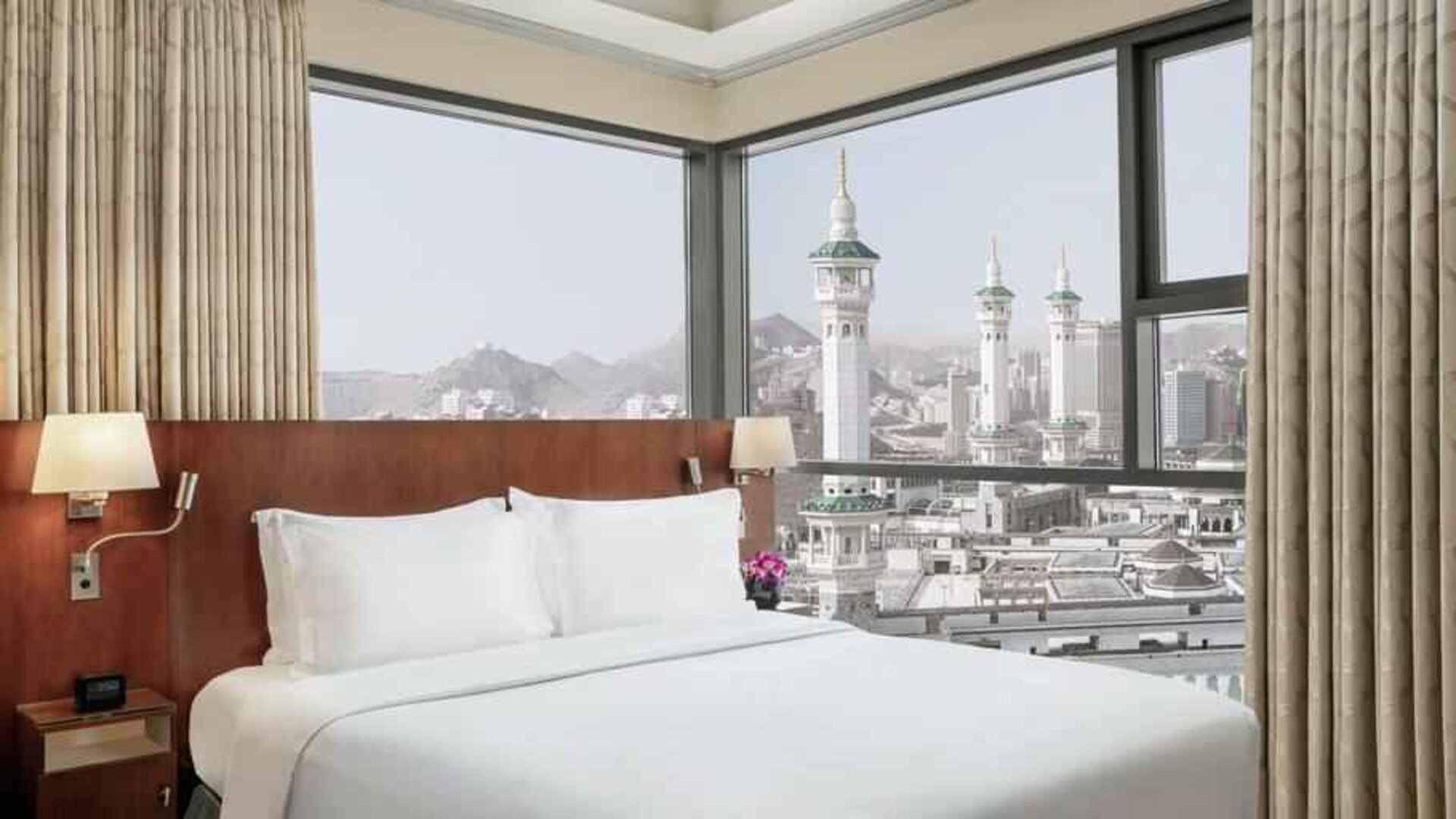 Hotel room with large windows and view at the Hilton Suites Makkah.