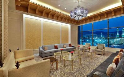 Seating area with large window and view at the Hilton Makkah Convention Hotel.