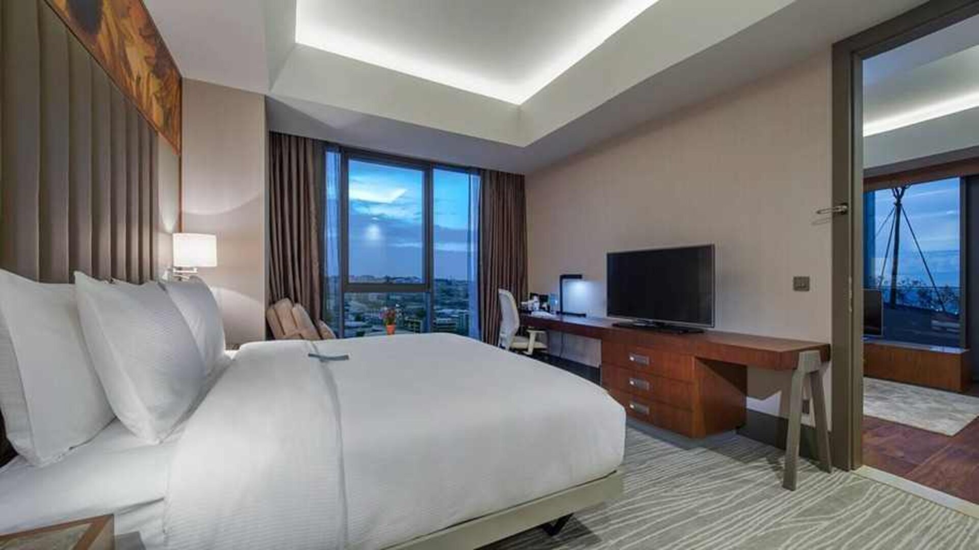 spacious king room with TV, work desk, chair, and couch at Hilton Garden Inn Istanbul Ataturk Airport.