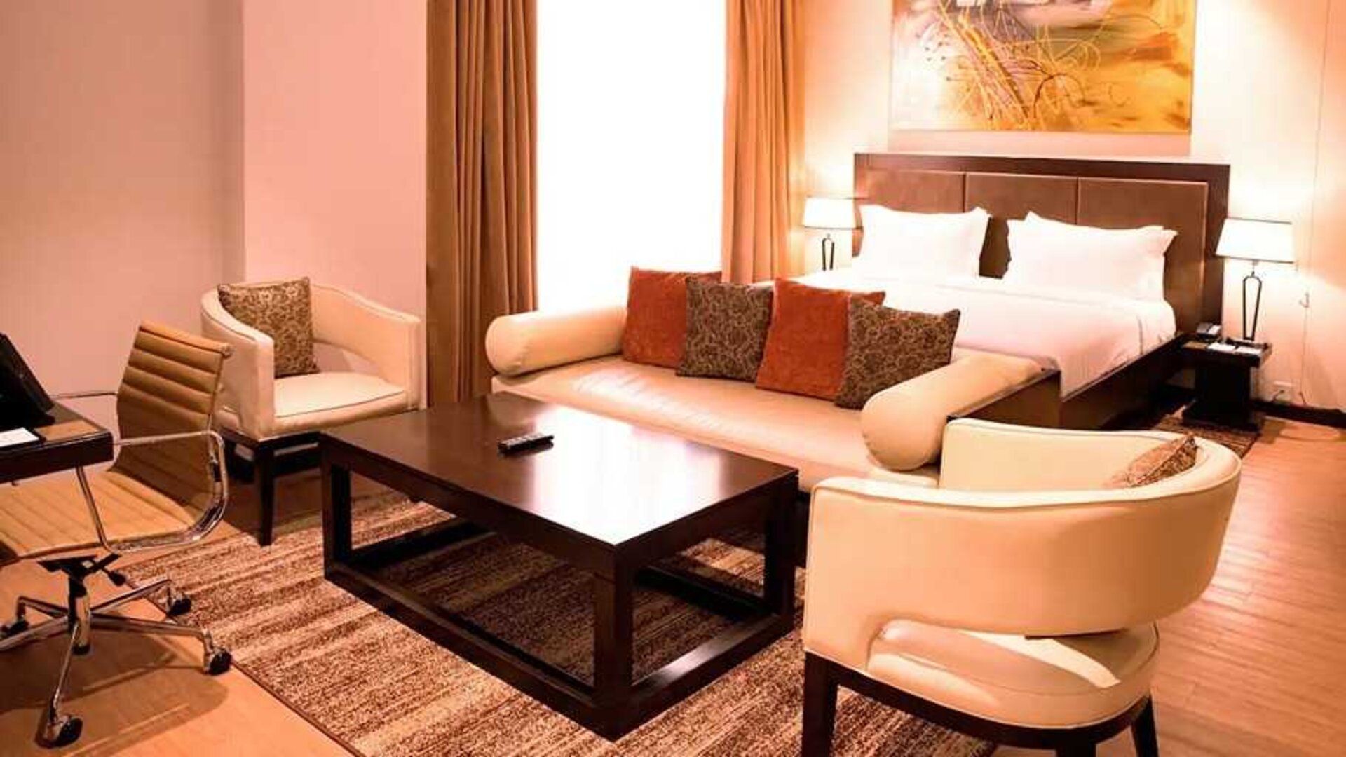 luxurious king suite with lounge area, business desk, and chair at DoubleTree by Hilton Nairobi Hurlingham.
