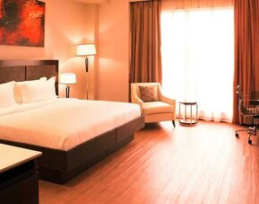 spacious king room with business desk, chair, TV, and couch at DoubleTree by Hilton Nairobi Hurlingham.