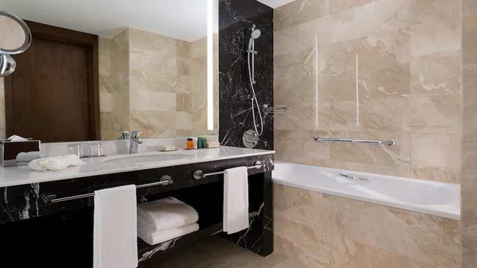 clean and spacious king bathroom with bath and shower at Hilton Astana.