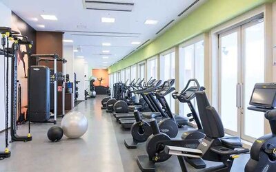 well equipped fitness center with treadmills, bicycles, and weights at Hilton Fukuoka Sea Hawk.