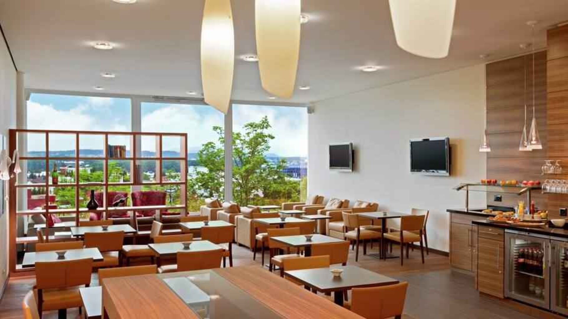 Seating area with TV screens at the Hilton Zurich Airport.