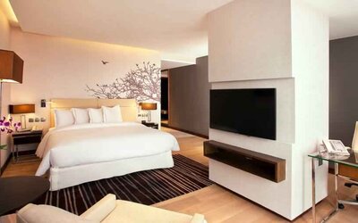 Spacious king bedroom with desk and TV screen at the Hilton Colombo Residence.