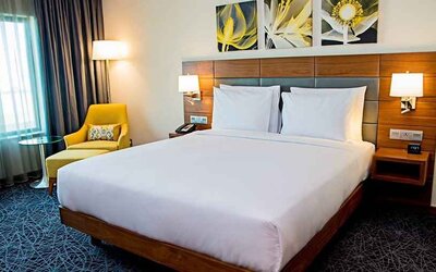 comfortable king room with couch and lots of natural light at Hilton Garden Inn Nairobi Airport.