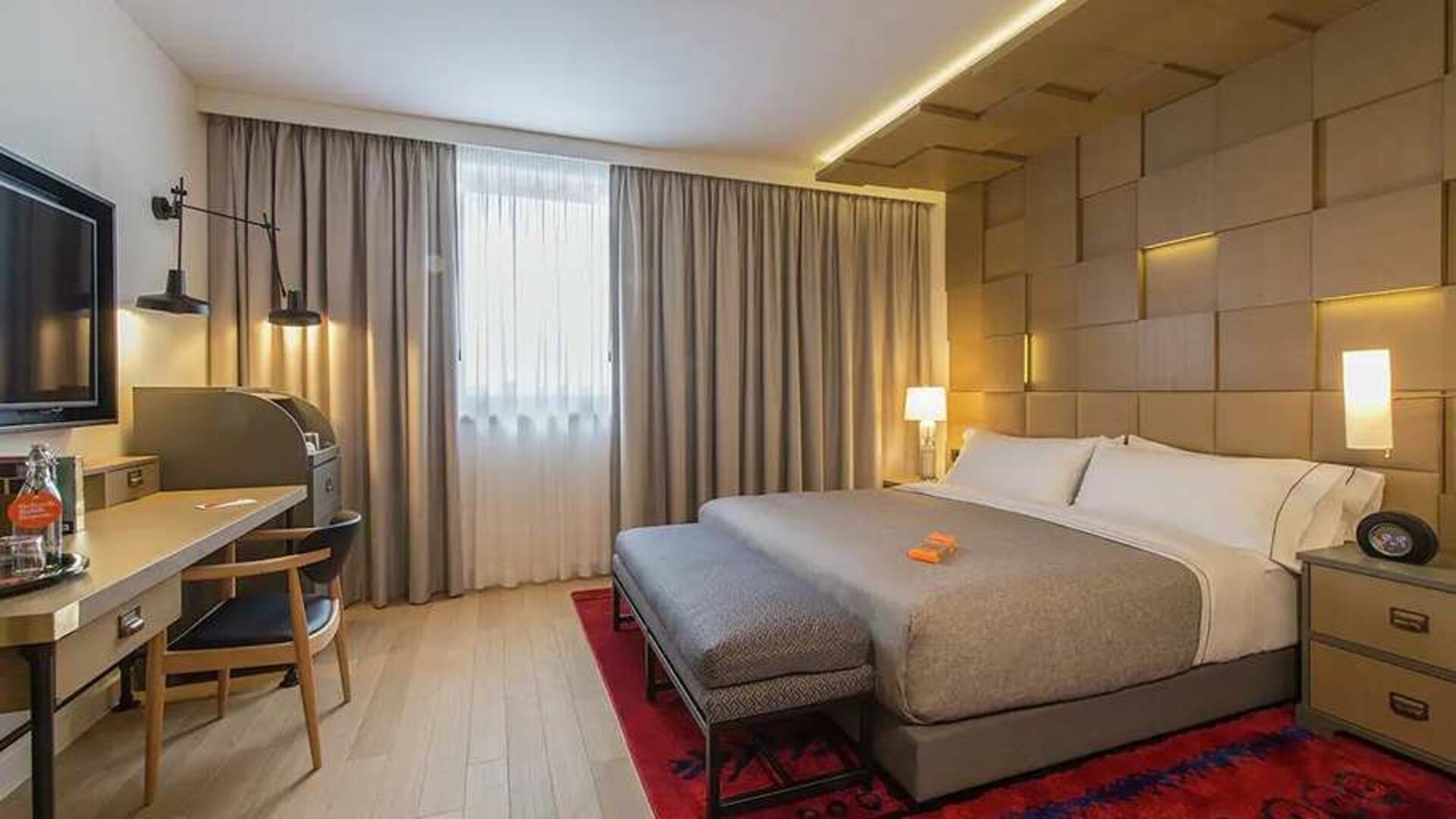 lovely king room with TV, work desk, and chair at Canopy by Hilton Zagreb City Centre.