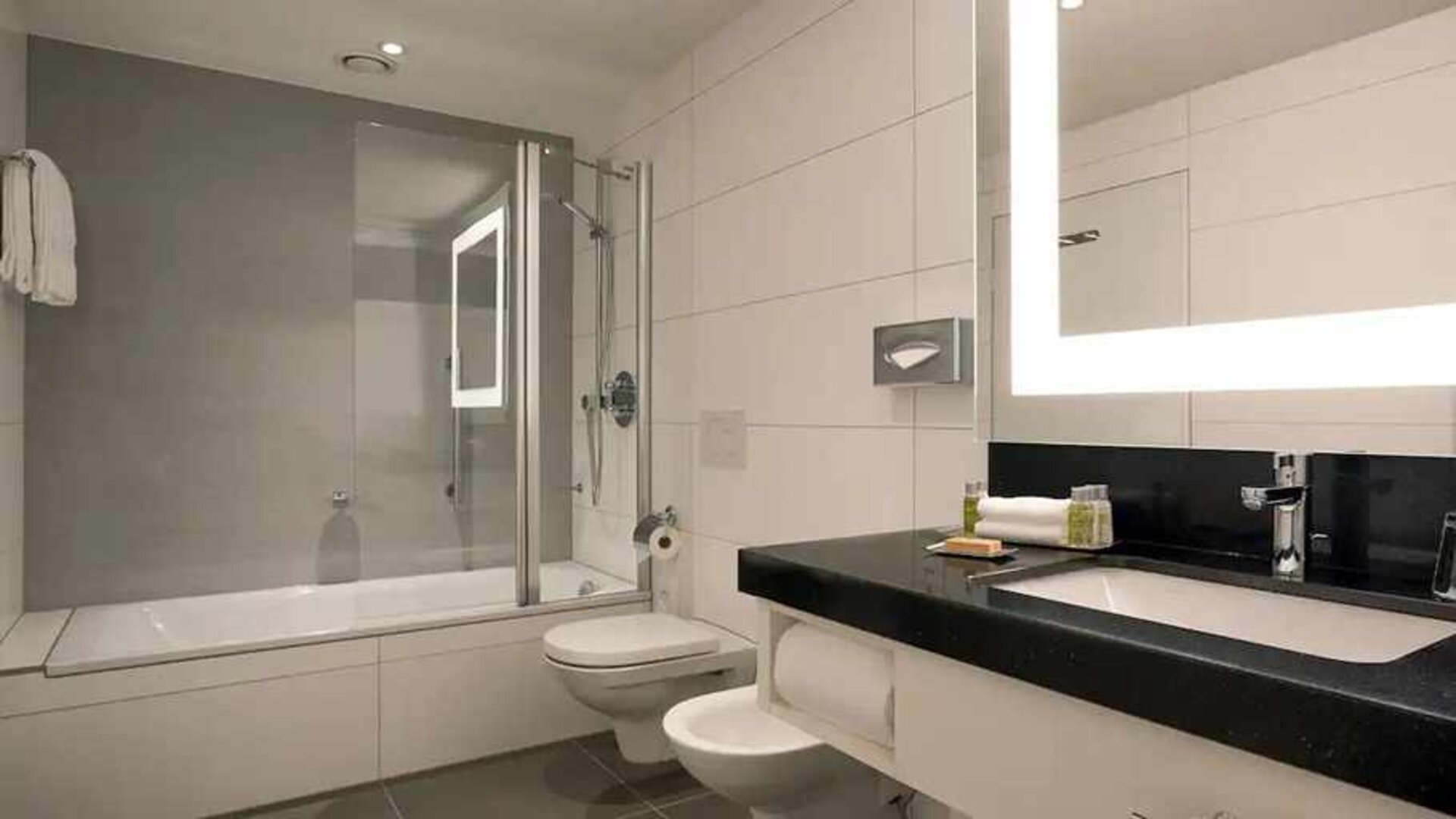 clean and spacious king bathroom with bath and shower combo at DoubleTree by Hilton Luxembourg.