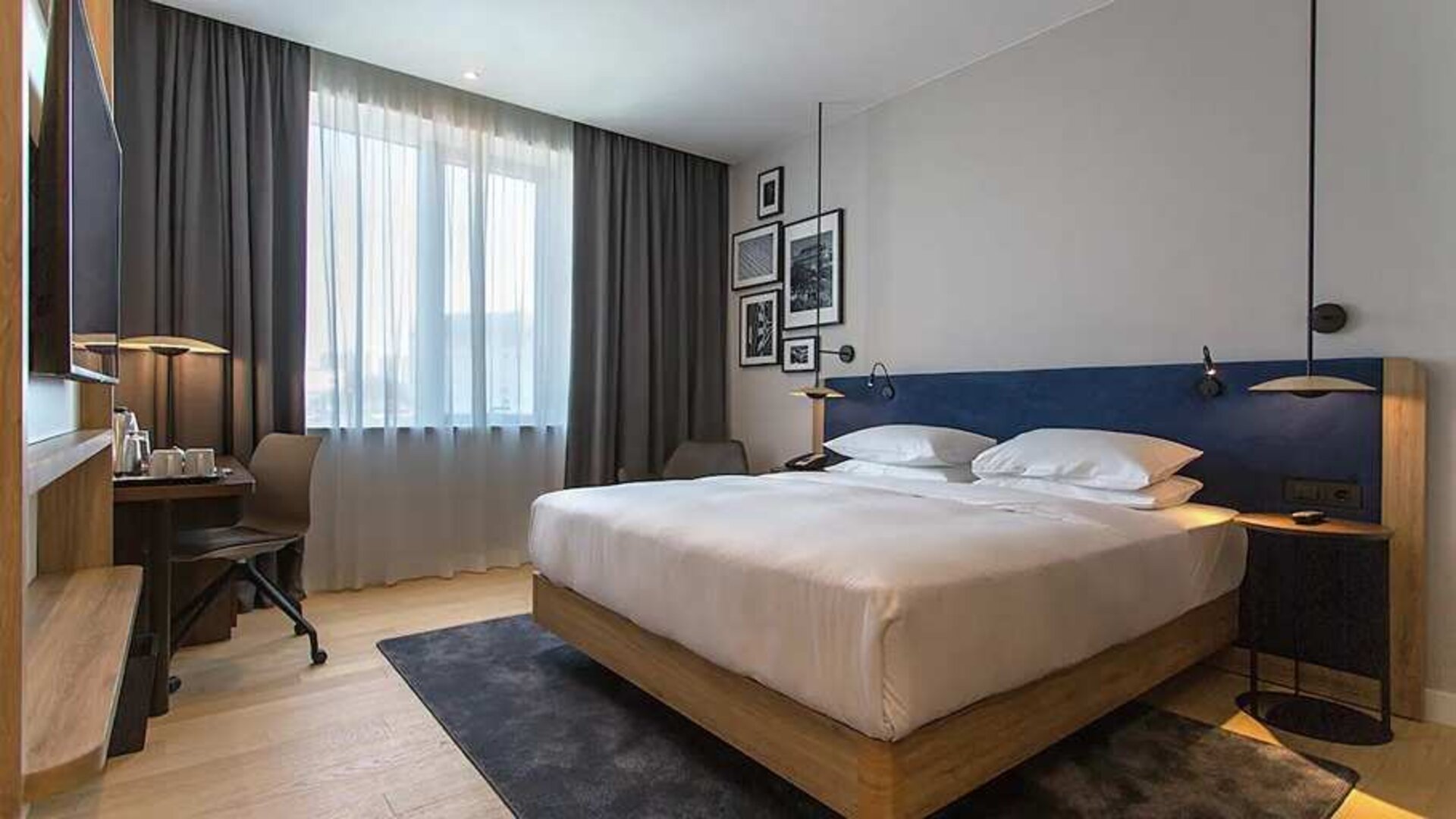 spacious king room with TV, work desk, and chair at Hilton Garden Inn Zagreb - Radnicka.