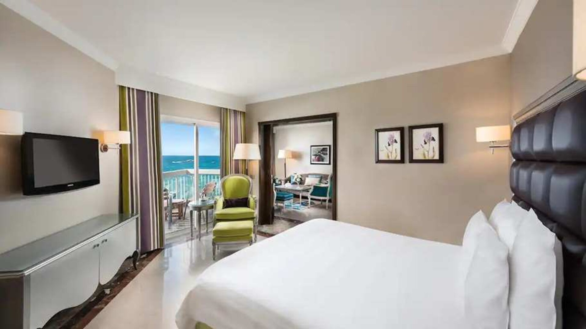luxurious king room with TV, outdoor terrace, and sea views at Hilton Alexandria Corniche.
