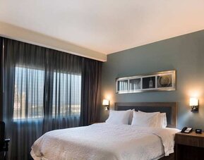 comfortable king suite with desk and chair at Hampton Inn & Suites by Hilton Salamanca Bajio.