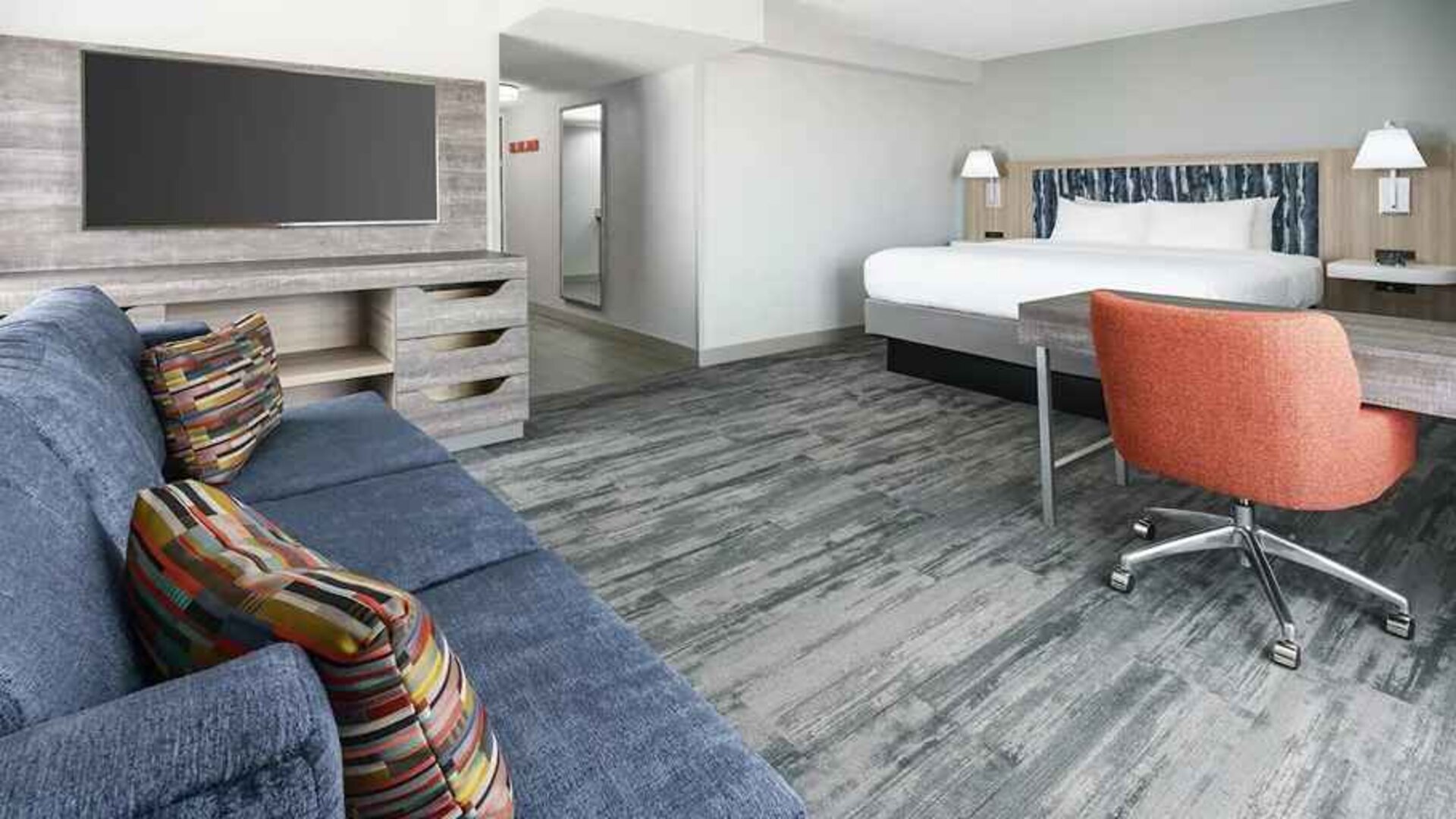 luxurious king suite with lounge and work area at Hampton Inn & Suites Tampa-Ybor City/Downtown.