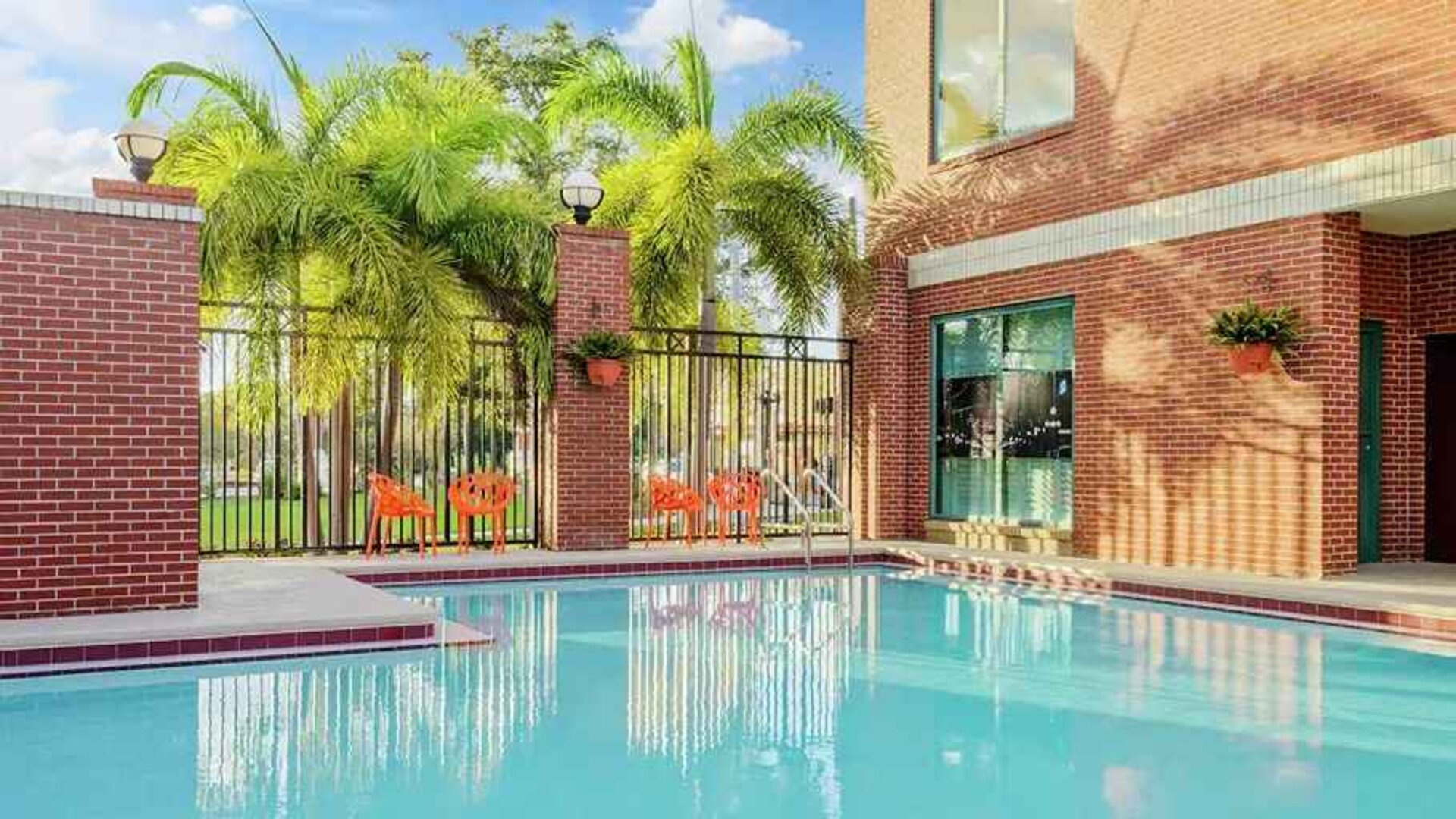 relaxing outdoor pool with seating area at Hampton Inn & Suites Tampa-Ybor City/Downtown.