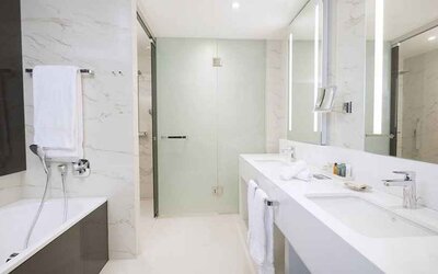 clean and spacious king bathroom with shower and bath at Hilton Tallinn Park.