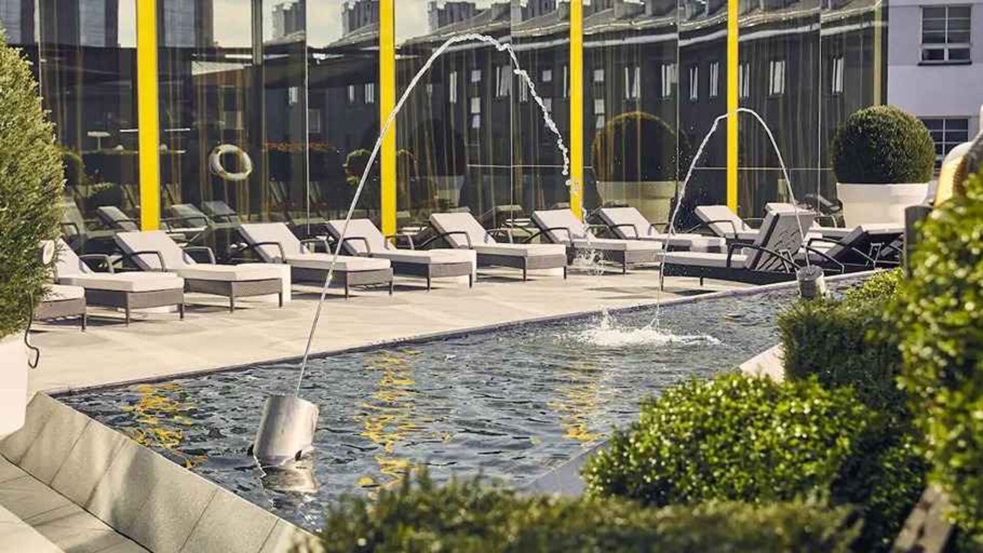 beautiful rooftop terrace with pool-fountain and sunbeds at Hilton Tallinn Park.