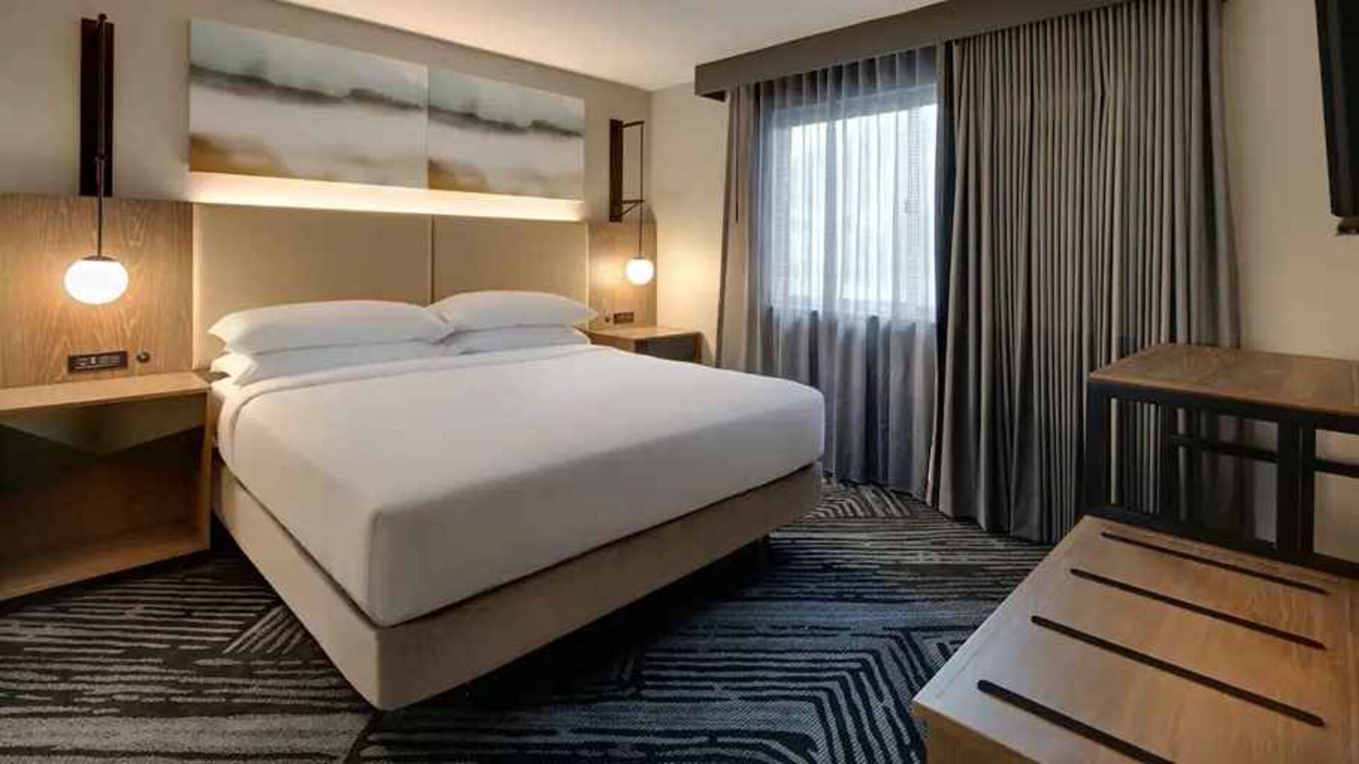 comfortable king room with cosy lighting at Embassy Suites by Hilton San Rafael Marin County.