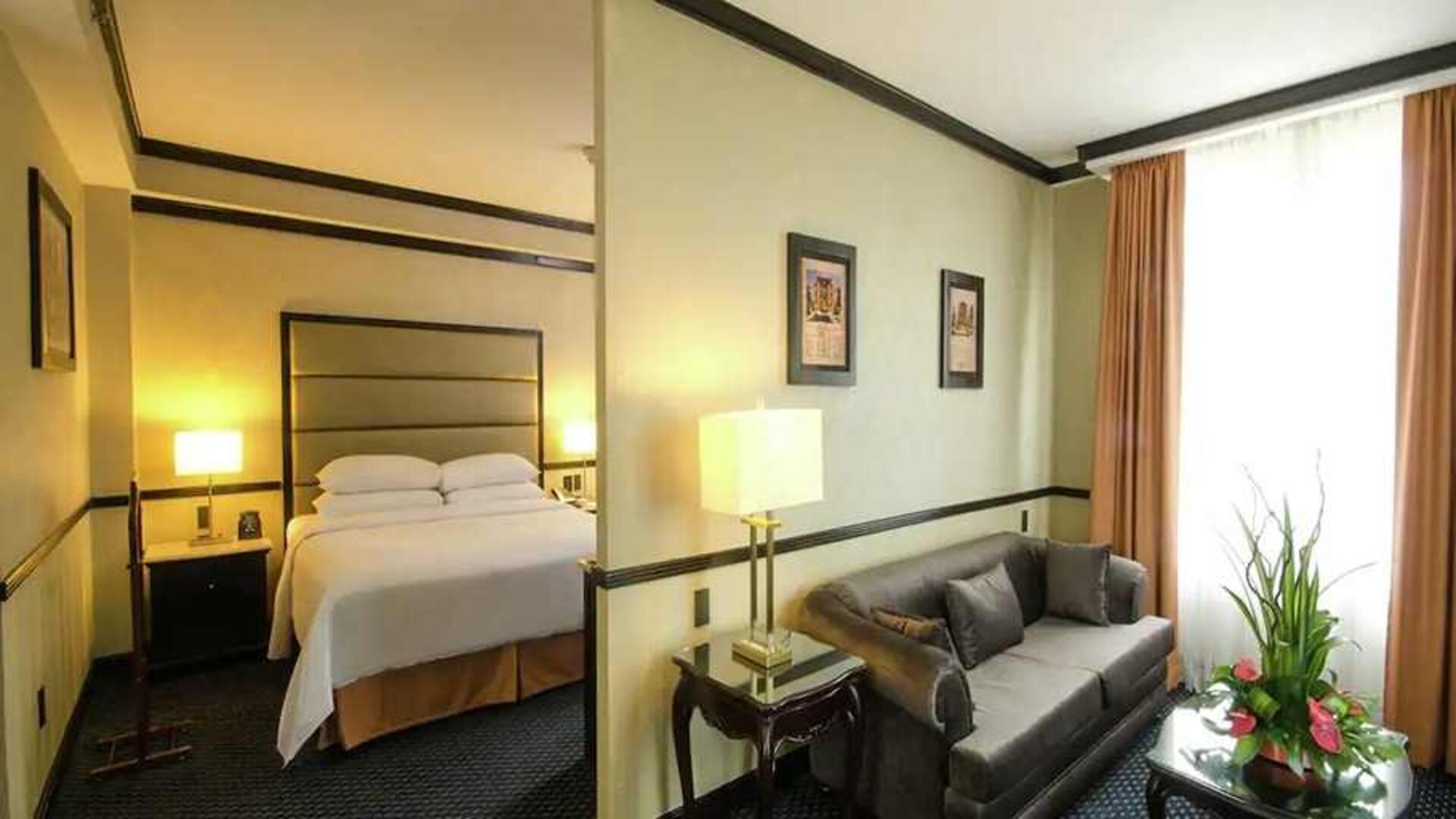 spacious king suite with comfortable lounge area at Hilton Princess San Pedro Sula.
