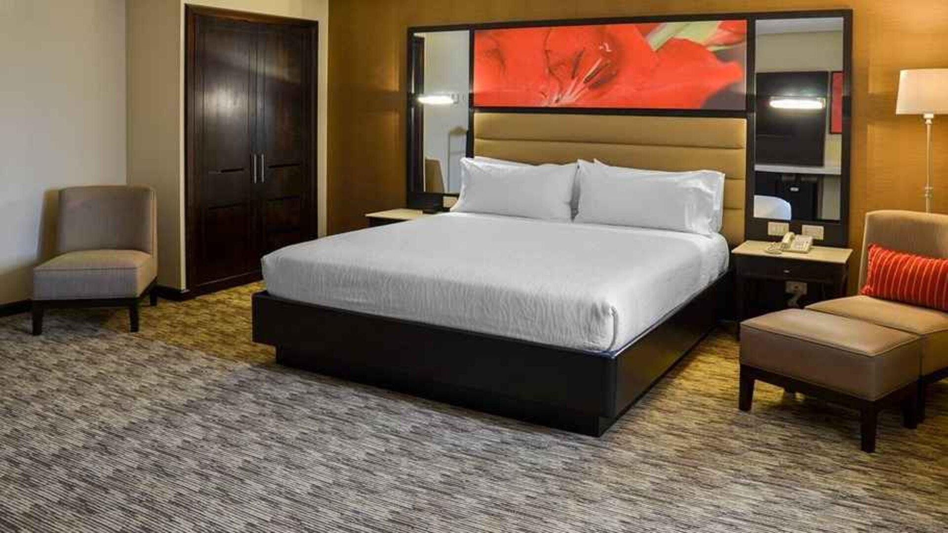 spacious king suite with comfortable couches at Hilton Garden Inn Guatemala City.