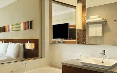 guest bathroom with bath and shower combo at Hilton Chennai.