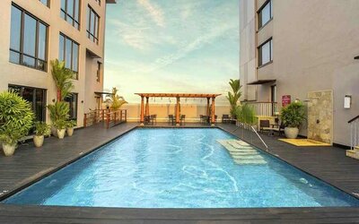 stunning outdoor pool with seating area at Hilton Garden Inn Trivandrum.