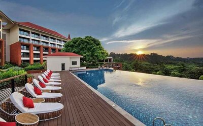 stunning outdoor infinity pool with sun beds at DoubleTree by Hilton Goa - Panaji.