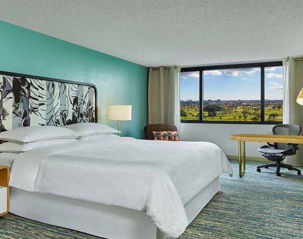 King bedroom with desk at the Sheraton Miami Airport Hotel.