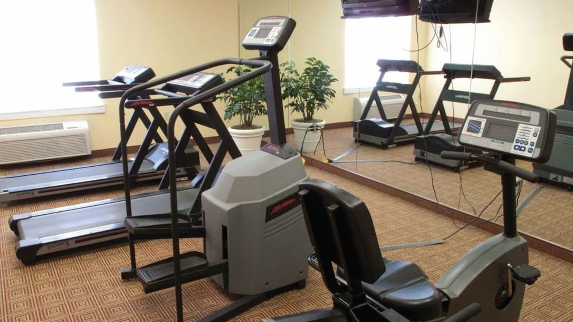Well-equipped gym featuring treadmills, exercise equipment, and fitness amenities available for guest use at La Quinta Inn & Suites By Wyndham Sawgrass Mills.